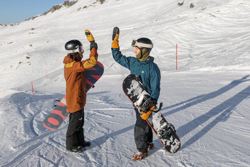 Snowboard instructor and student high fiving after a private lesson in Engelberg